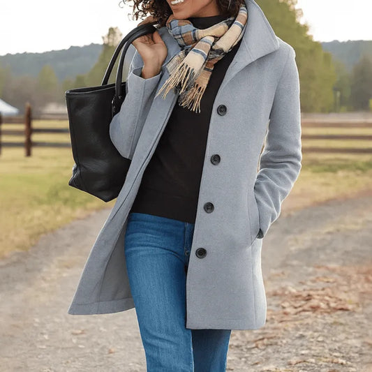 Women's wool-blend coat by Homixa featuring a tailored fit, button front, notched lapels, and side pockets, shown on a model.