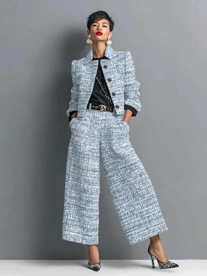 Women's tweed suit by Homixa featuring a cropped blazer, structured shoulders, and wide-leg trousers, styled for a polished look.