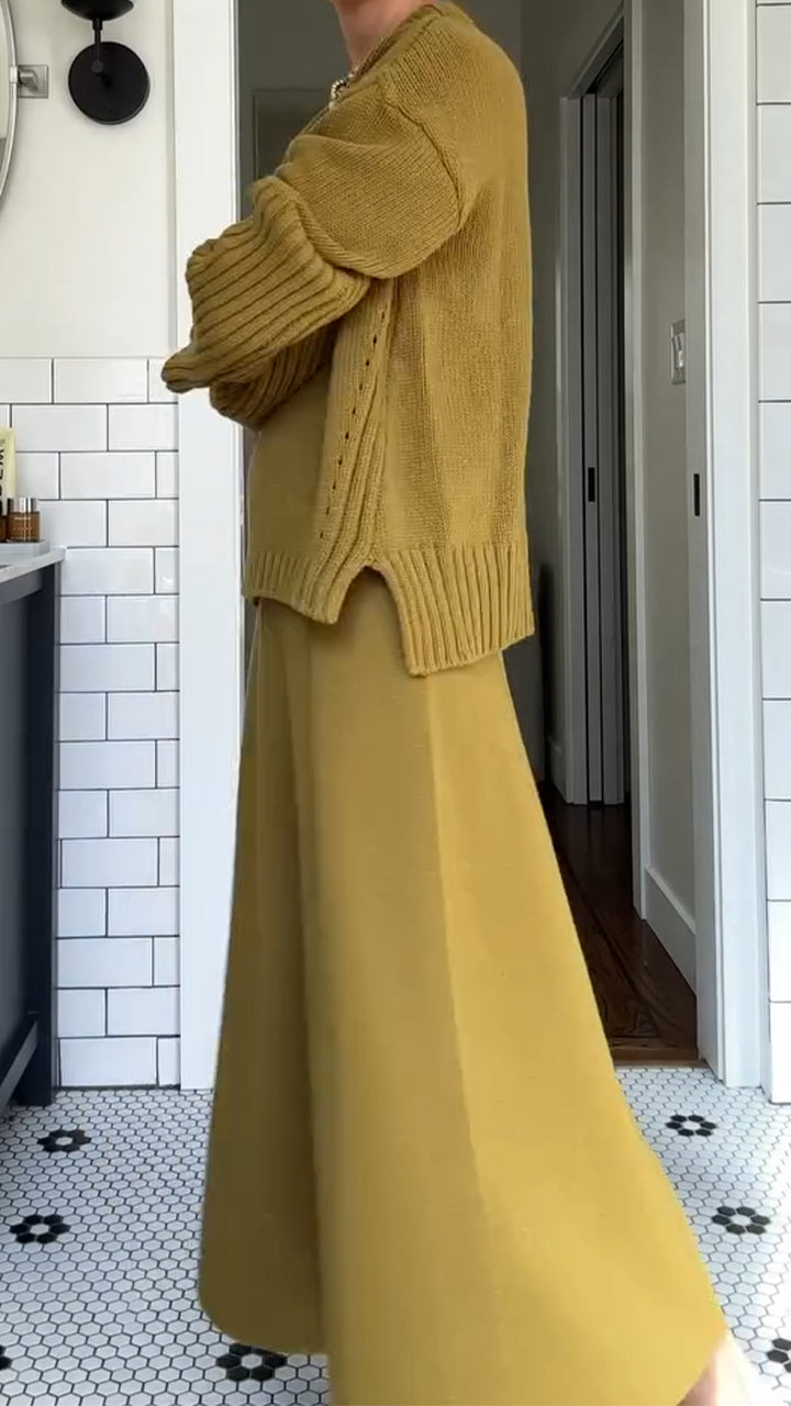 Women’s two-piece set by Homixa featuring an oversized soft-knit sweater and a flowing maxi skirt, styled for casual elegance.