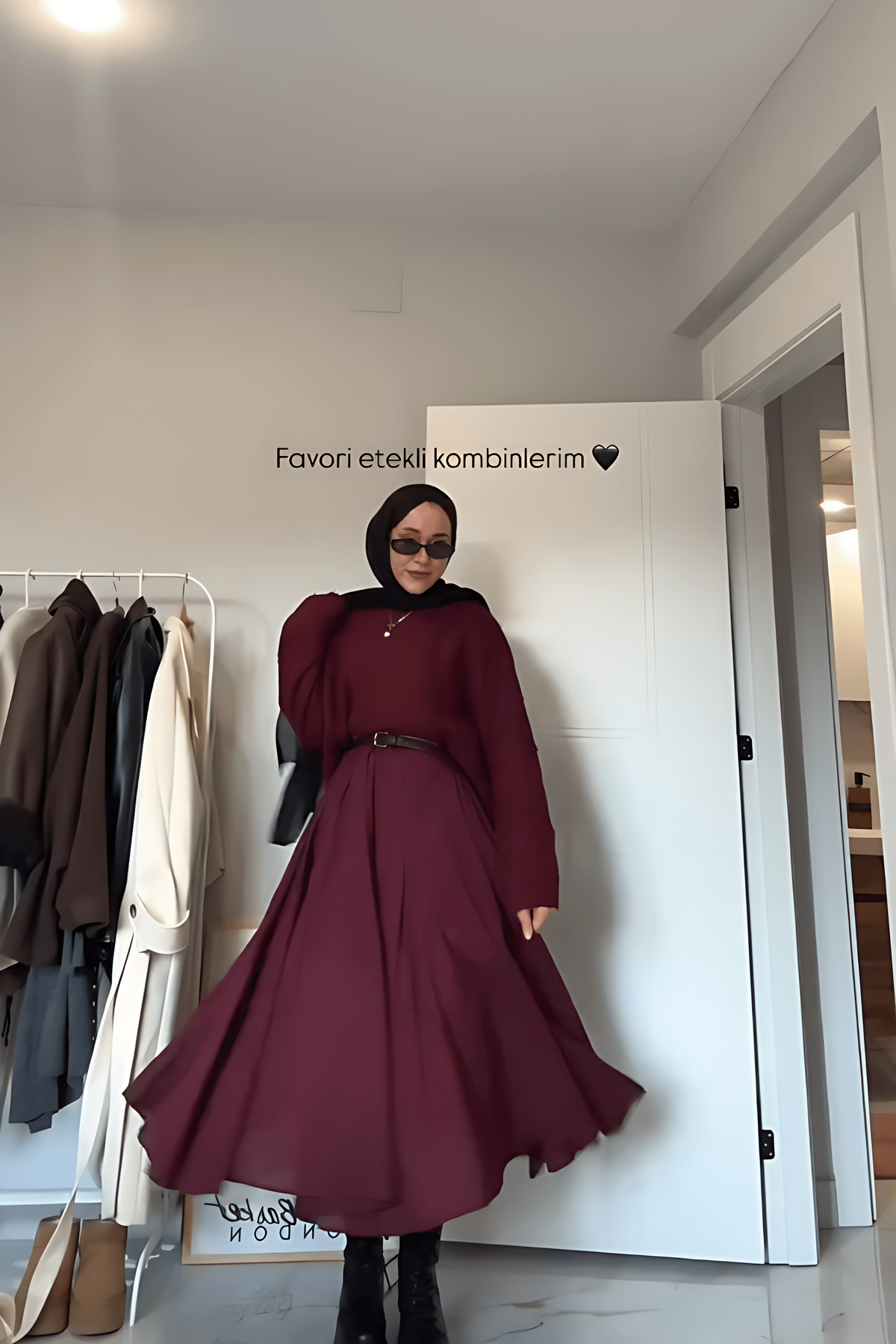 Women's two-piece set by Homixa featuring a soft knit sweater and flowing pleated midi skirt, displayed on a model.