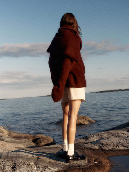 Women's two-piece set by Homixa featuring a soft knit sweater and a flowing pleated midi skirt, styled together for a chic look.