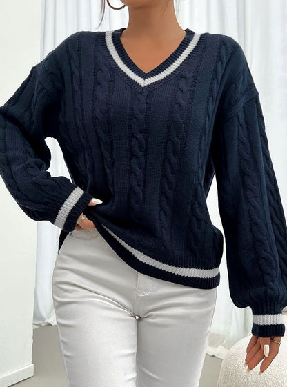 Women's V-neck cable sweater by Homixa featuring drop-shoulder design and contrast trim, displayed on a model.