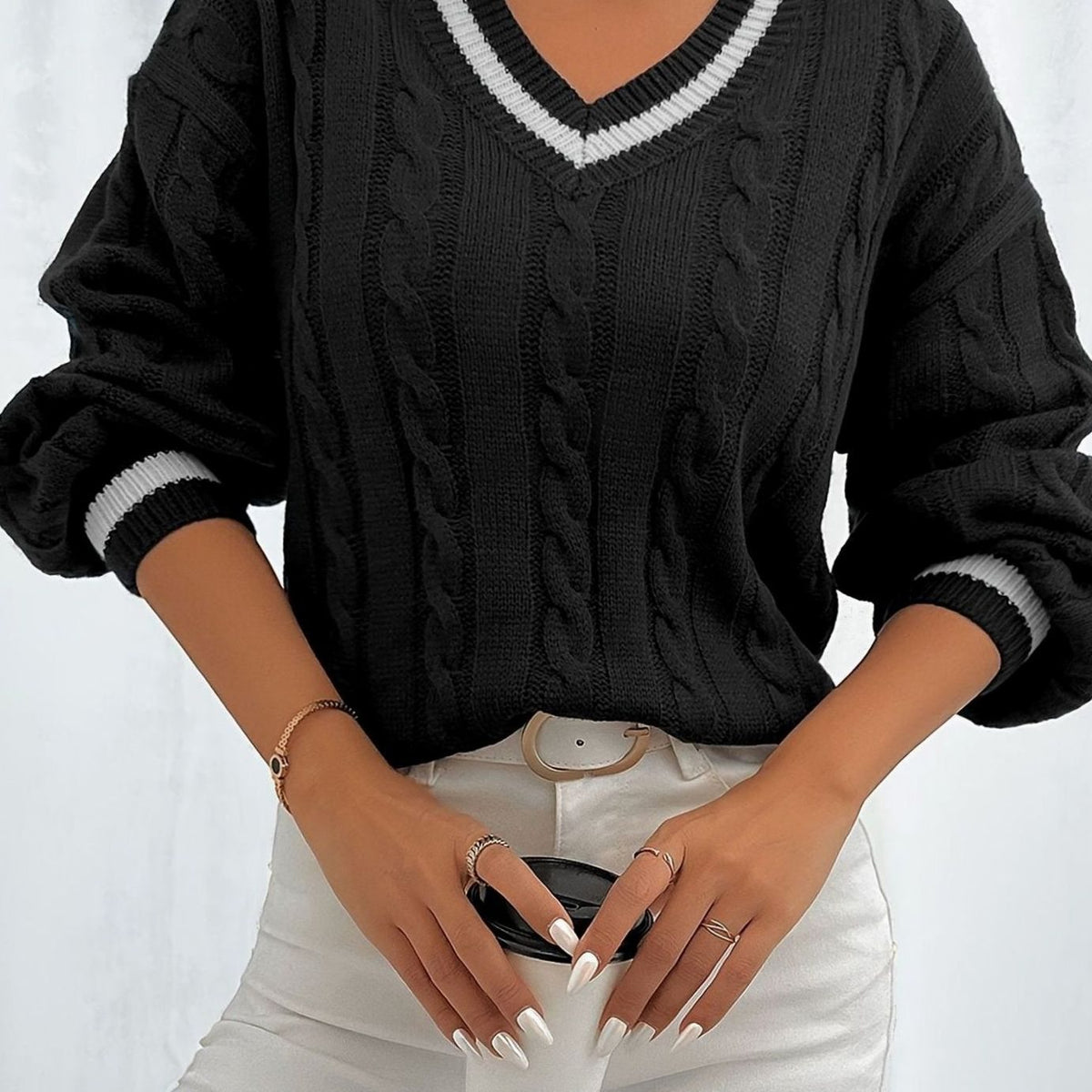 Women's Homixa V-neck cable sweater with drop-shoulder design and contrast trim, featuring cozy knit texture and stylish details.