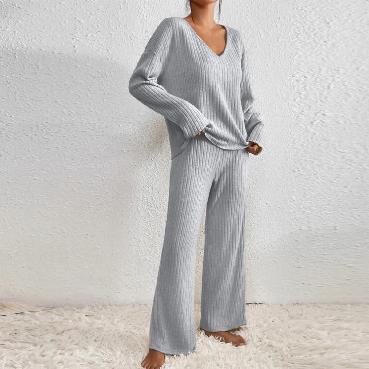 Women’s V-neck knit two-piece set by Homixa featuring a long-sleeve top and elastic-waist pants, displayed on a model.