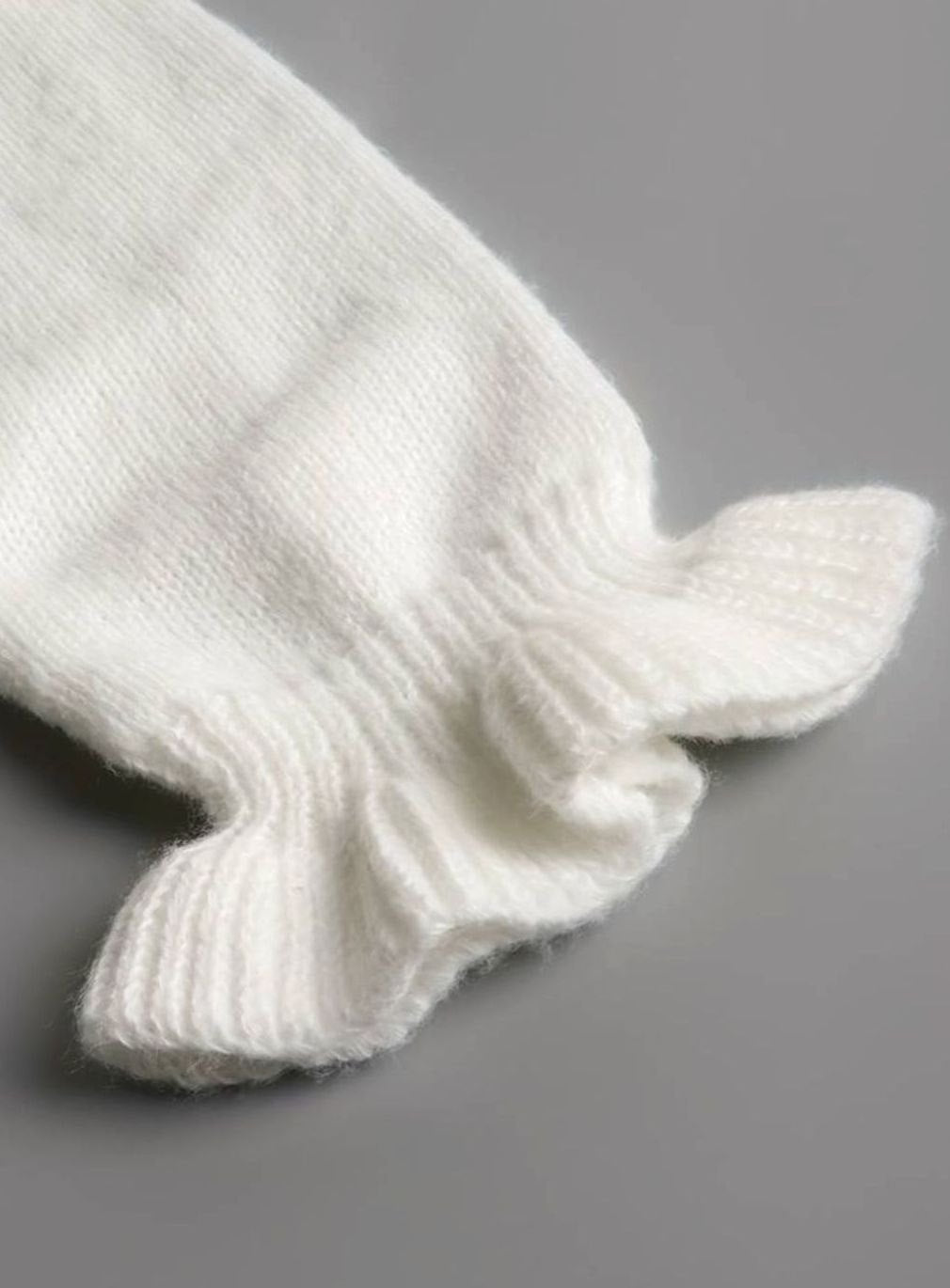 Homixa women's V-neck sweater with pearl buttons, ruffle trim at neck and cuffs, made of soft knit fabric.