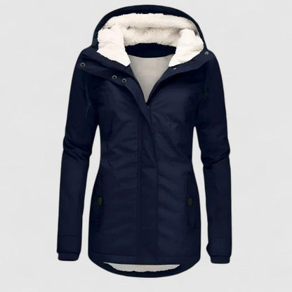 Women's waterproof hooded winter coat with fleece lining, zip front, and hip pockets by Homixa in a winter outdoor setting.