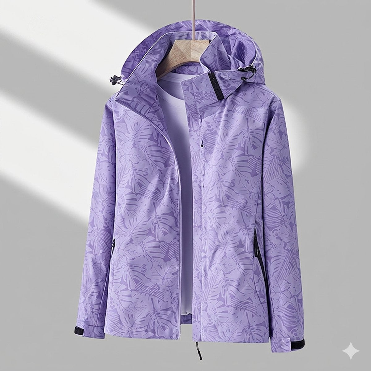 Women’s waterproof lined winter jacket by Homixa with adjustable hood and zip side pockets, shown on a model in outdoor setting.