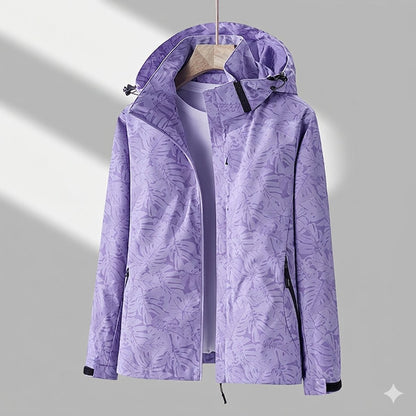Women’s waterproof lined winter jacket by Homixa with adjustable hood and zip side pockets, shown on a model in outdoor setting.