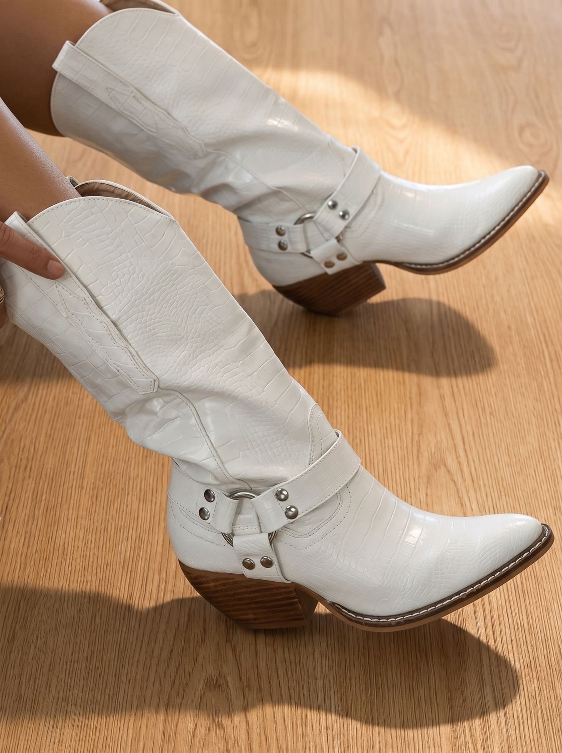 Homixa women's western knee-high boots with pointed toe, block heel, and harness straps, showcasing a stylish and sturdy design.
