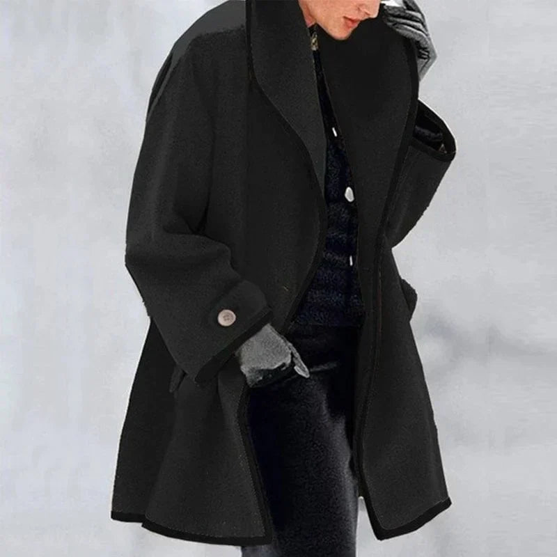 Homixa Agnes women's merino wool trench coat with statement collar, contrast trim, and buttoned cuffs in black fabric.